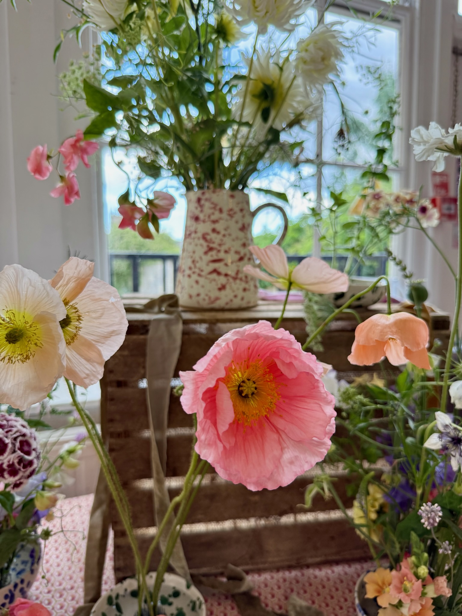 Close-up of pink poppies and blooms at a floral workshop