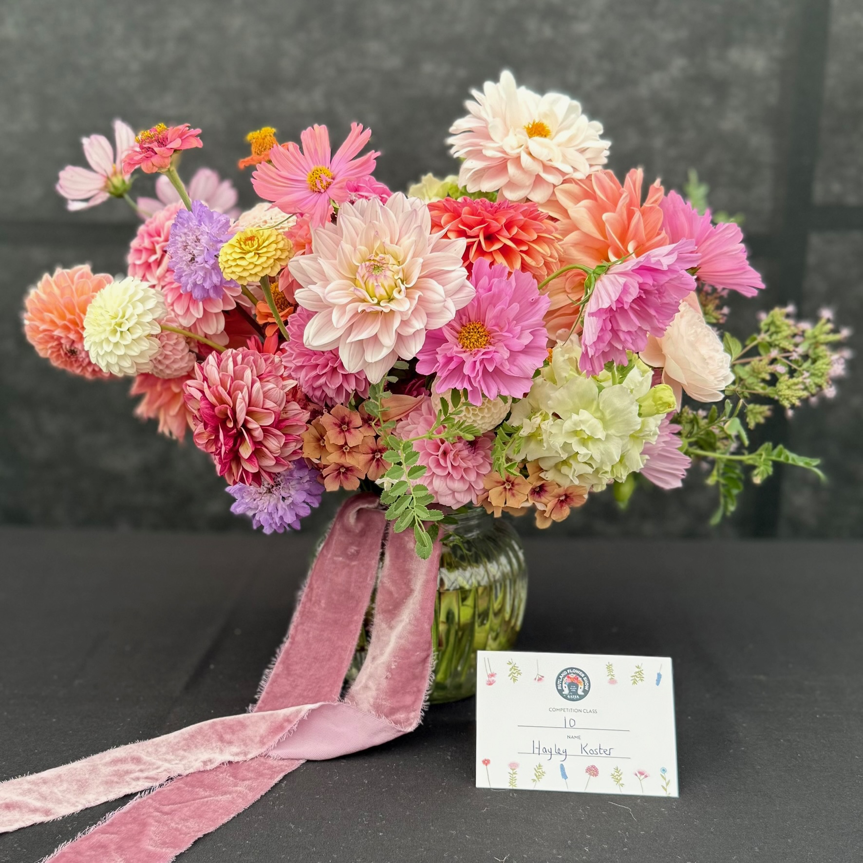 A vibrant floral competition arrangement by Hayley Koster with dahlias, cosmos and zinnias